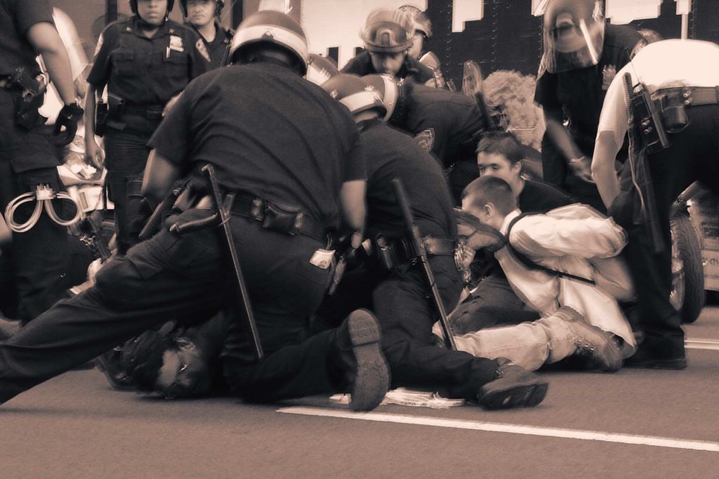 Police arrest a protester outside in New York City during protests against the 2004 Republican National Convention.